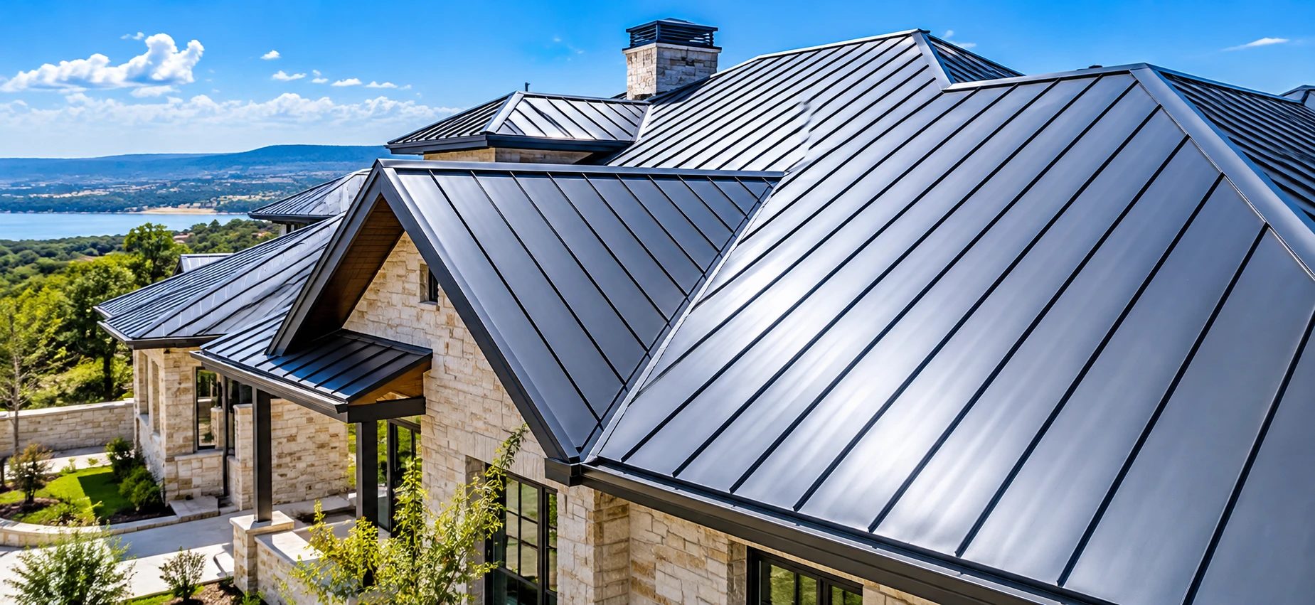 Stone lake-view home with a charcoal standing seam metal roof
